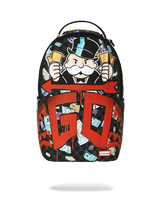 A Sprayground backpack featuring a black and white checkerboard pattern with a cartoon character holding money, large red 'GO' lettering, and scattered dollar bill graphics, shown on a white background with a soft shadow below.