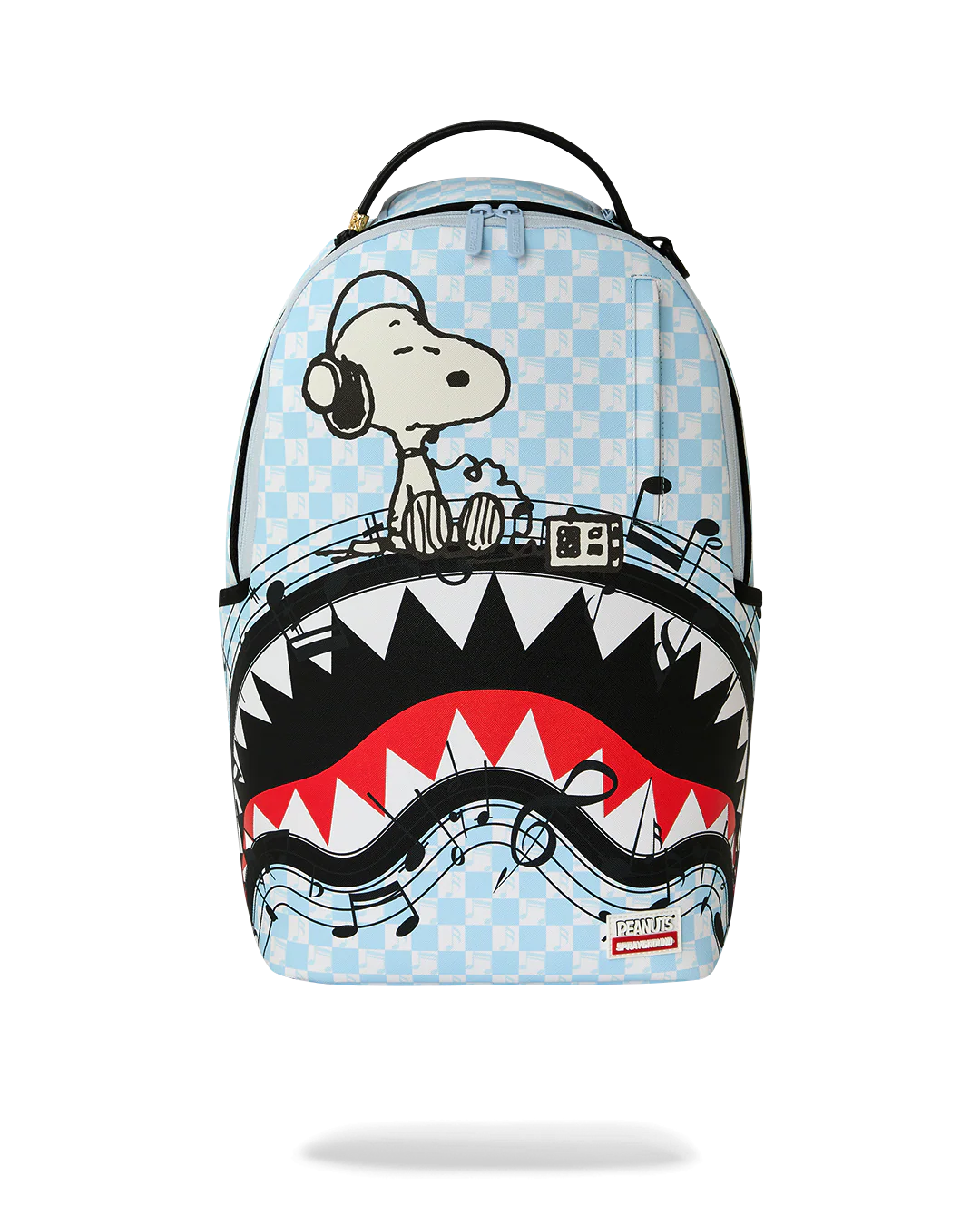 A light blue checkered backpack featuring a graphic of Snoopy behind a DJ turntable, with a shark mouth design in black, white, and red below. The backpack has a top handle and a small Spraycraft logo patch near the bottom right.