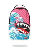 A backpack featuring a graphic print of the Pink Panther surfing on a giant shark wave, styled after 'The Great Wave off Kanagawa'. The top portion of the backpack has a pink and white checkerboard pattern, and the brand label 'SPRAYGROUND' is visible in a red box near the bottom right.