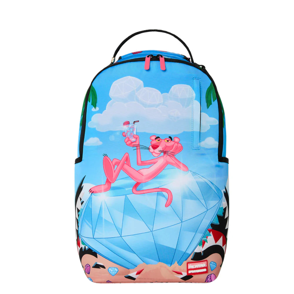 A Sprayground backpack featuring a colorful cartoon print of the Pink Panther lounging on a large blue diamond under a cloudy sky, with black side panels and a black top handle.