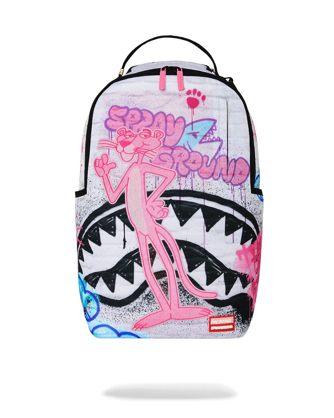 A Sprayground backpack featuring a pink cartoon character on a white background with graffiti-style graphics, including a shark mouth design.