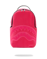 A bright pink Sprayground shark backpack with a large embossed shark mouth design on the front, black trim, and a top carry handle, shown against a plain white background.