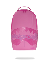 A bright pink Sprayground backpack featuring a large shark-mouth graphic with white teeth and a stylized spray-paint logo across the front, shown on a white background with a soft shadow underneath.