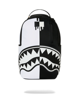 A black and white backpack featuring a split design with a dripping paint logo on the upper back and a shark-mouth graphic across the lower half, shown against a plain white background.
