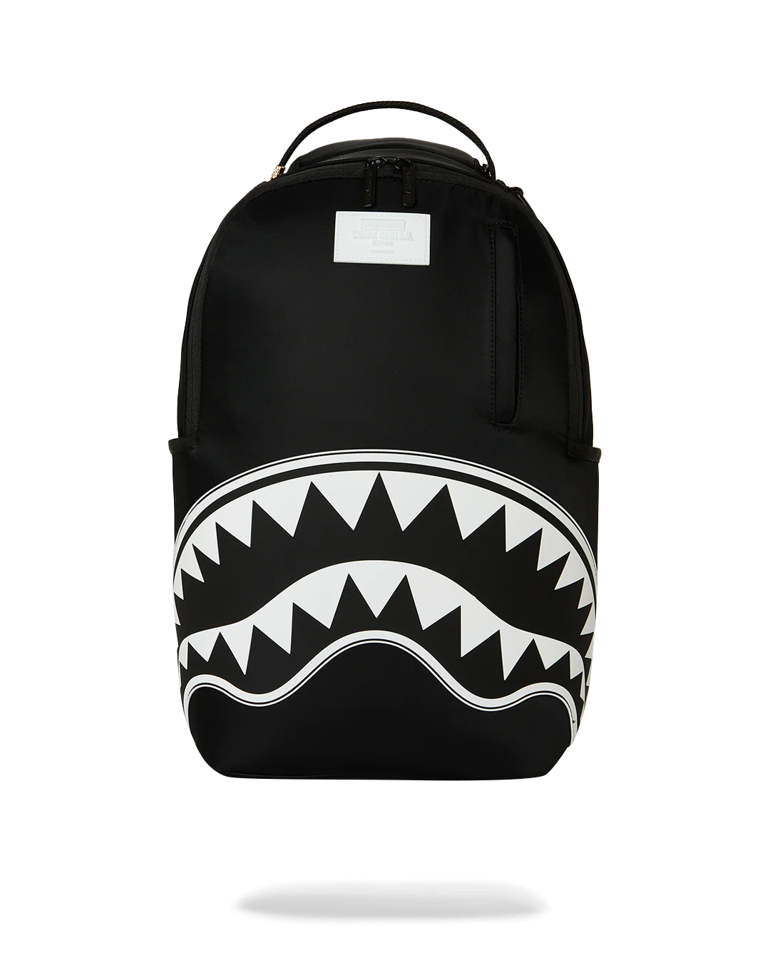 A black backpack featuring a bold white shark mouth graphic with sharp teeth across the lower front, shown on a clean white background.