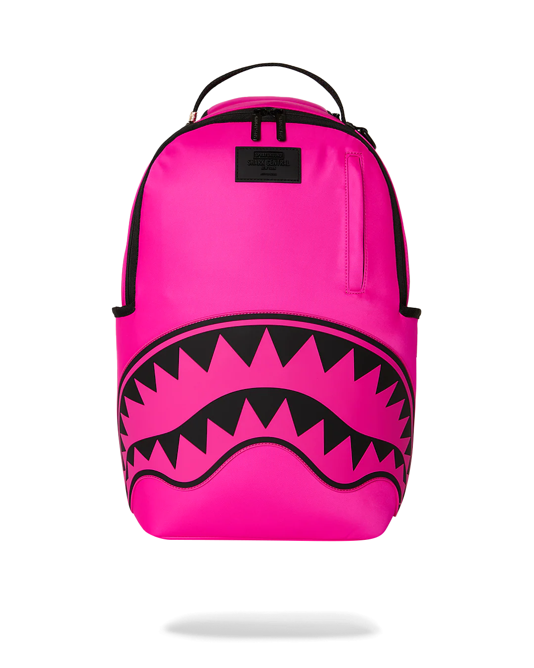 Bright pink backpack with a black shark-mouth graphic on the front and a top carry handle, shown on a white background.