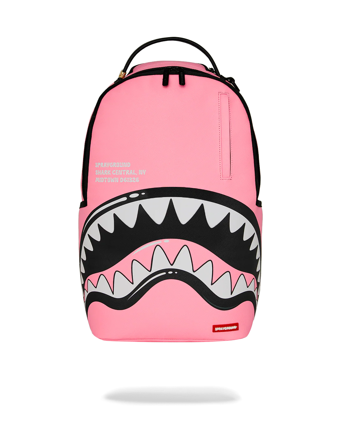 Pink backpack with shark mouth design on a white background