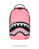 Pink backpack with shark mouth design on a white background
