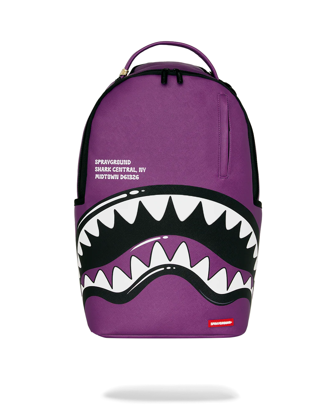Purple backpack with shark mouth design and Sprayground logo on a white background