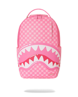 A pink Shark Day backpack featuring a pink and white checkerboard pattern, a large shark mouth graphic with white teeth across the lower front, and a top carry handle, shown on a white background with a soft shadow underneath.
