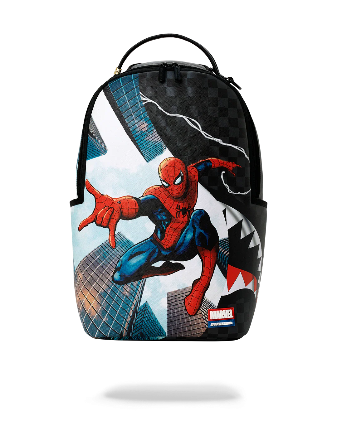 A backpack featuring a Spider-Man graphic print, designed by Sprayground in collaboration with Marvel. The backpack has a black top handle, black side pockets, and a graphic print of Spider-Man in his classic red and blue suit against a cityscape background with a shark mouth design on the right side.