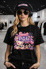 Person wearing a black t-shirt with colorful graphic design, black cap, and headphones in a store setting.