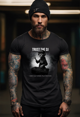 Man wearing a black t-shirt with 'Trust the DJ' graphic design.