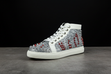 High-top sneaker with silver and red spike details on a white background