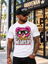 White No Days Off pink teddy bear graphic T-shirt worn with dark jeans and sunglasses outside Grooveman Miami Beach.