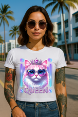 Woman wearing a white t-shirt with a colorful cat graphic and 'Queen' text, standing outdoors with palm trees in the background.