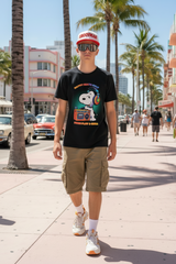 Black t-shirt with Snoopy graphic and text on a hanger against a dark background