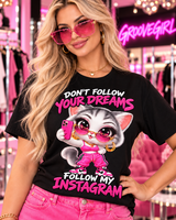 Close-up of the pink kawaii cat selfie design and Follow My Instagram slogan on a black women's tee.
